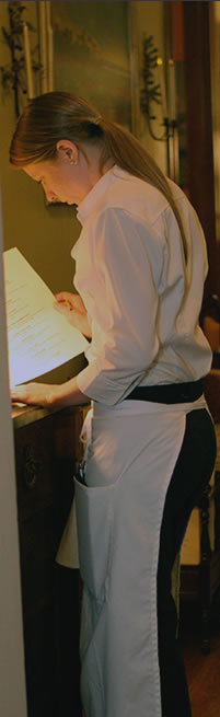 member of staff preparing an evenings menu.